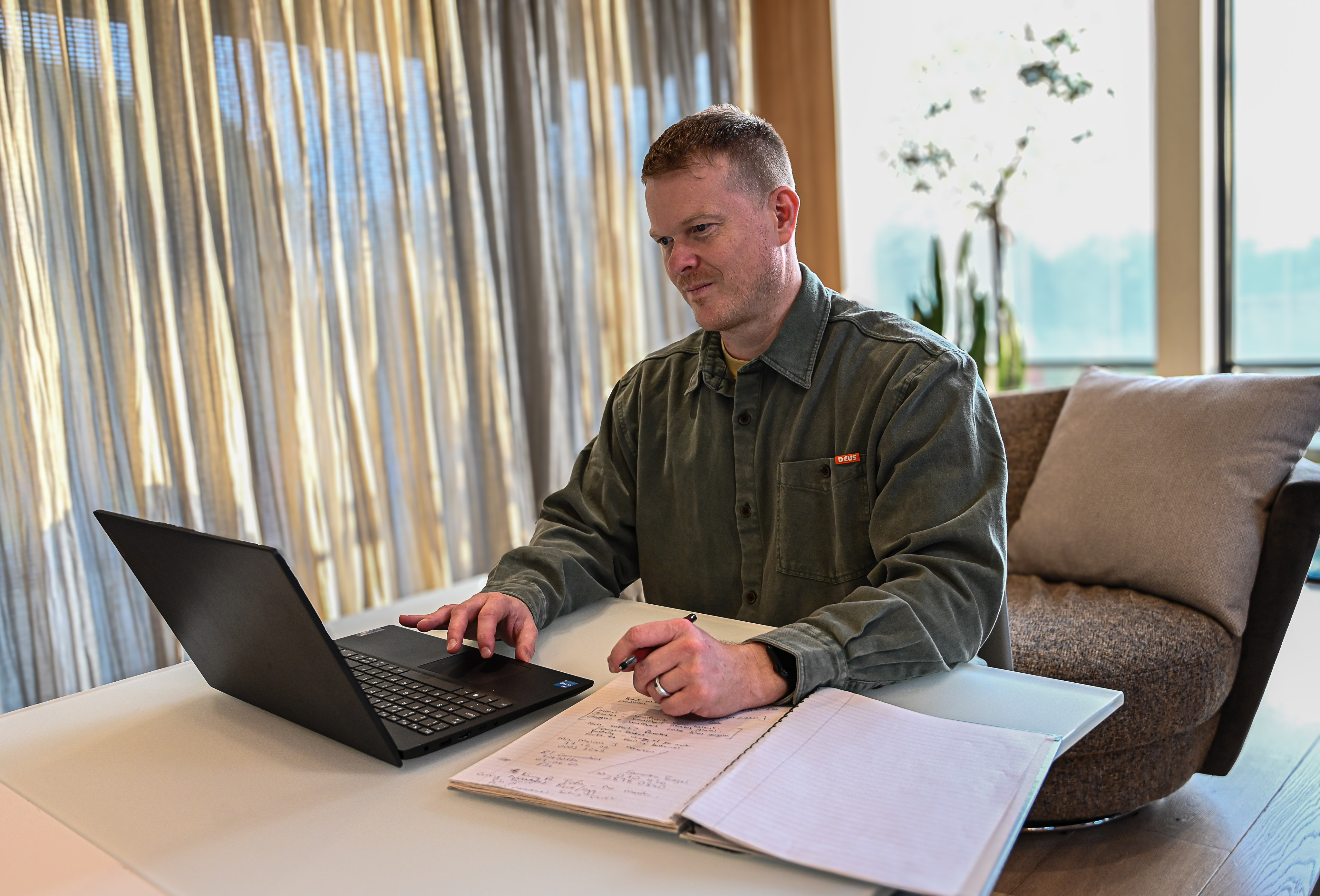Person working at laptop reviewing EHCP documents